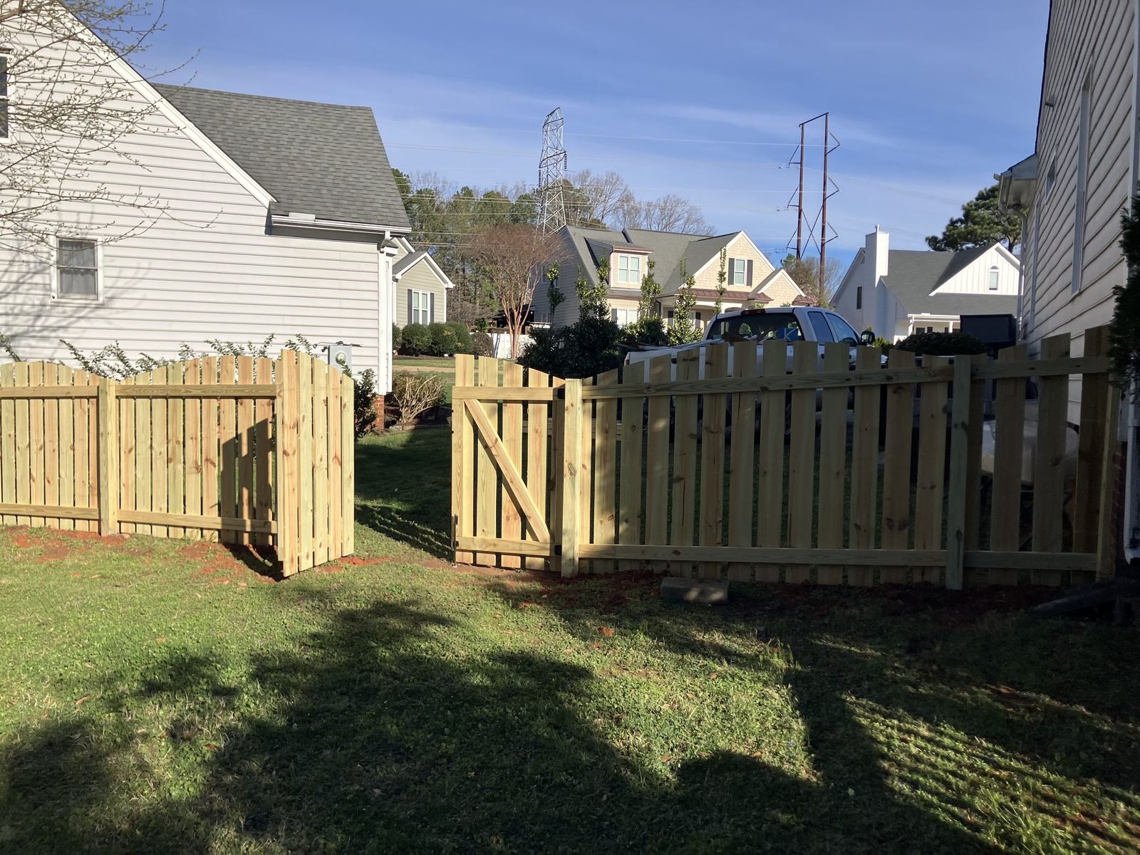 Wood picket fence with open double gate