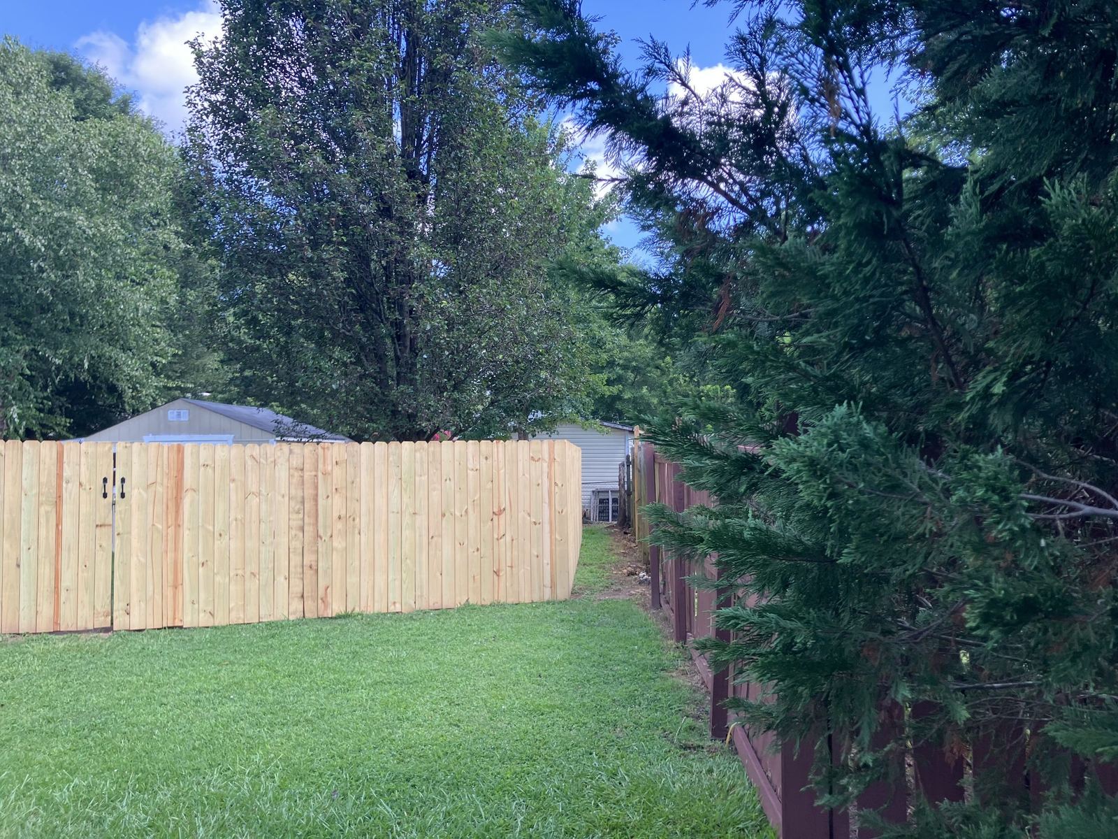 Finished wood fence project in a residential yard