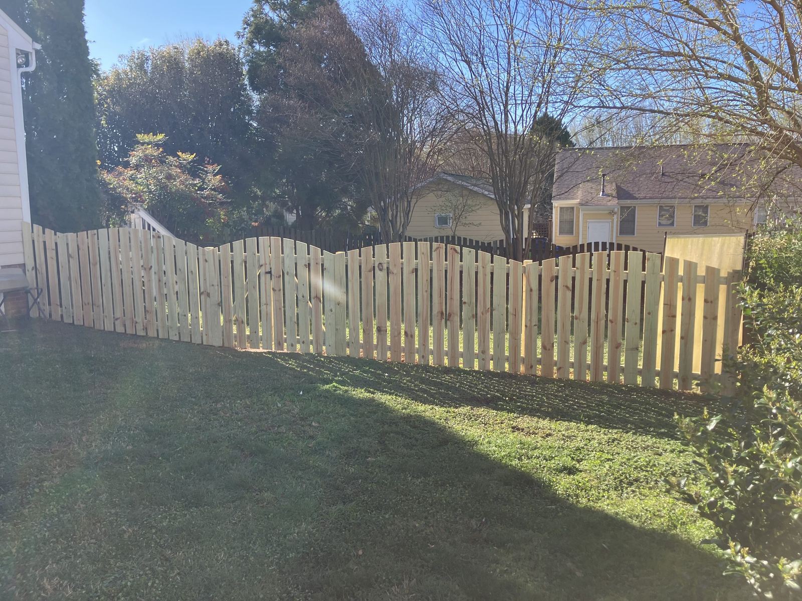 Scalloped wood picket fence with gate
