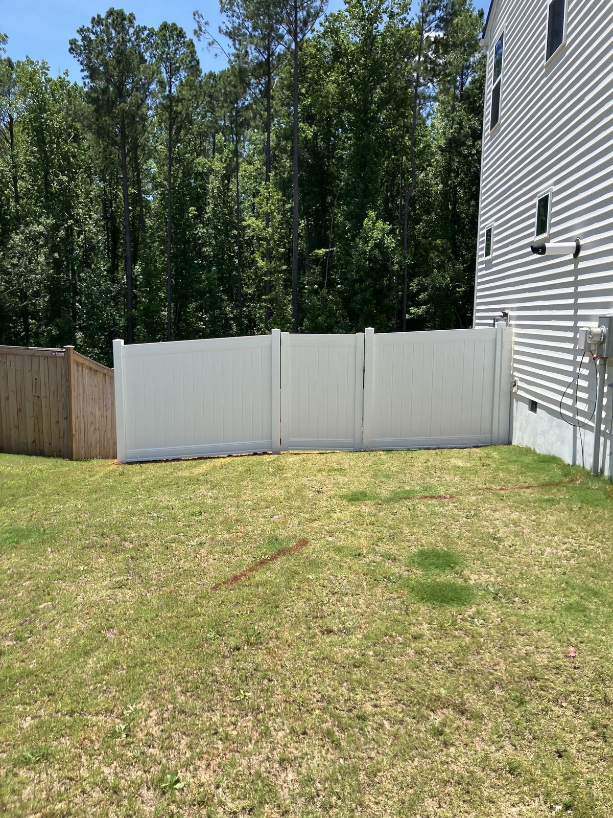 Wood fence panels installed for backyard privacy