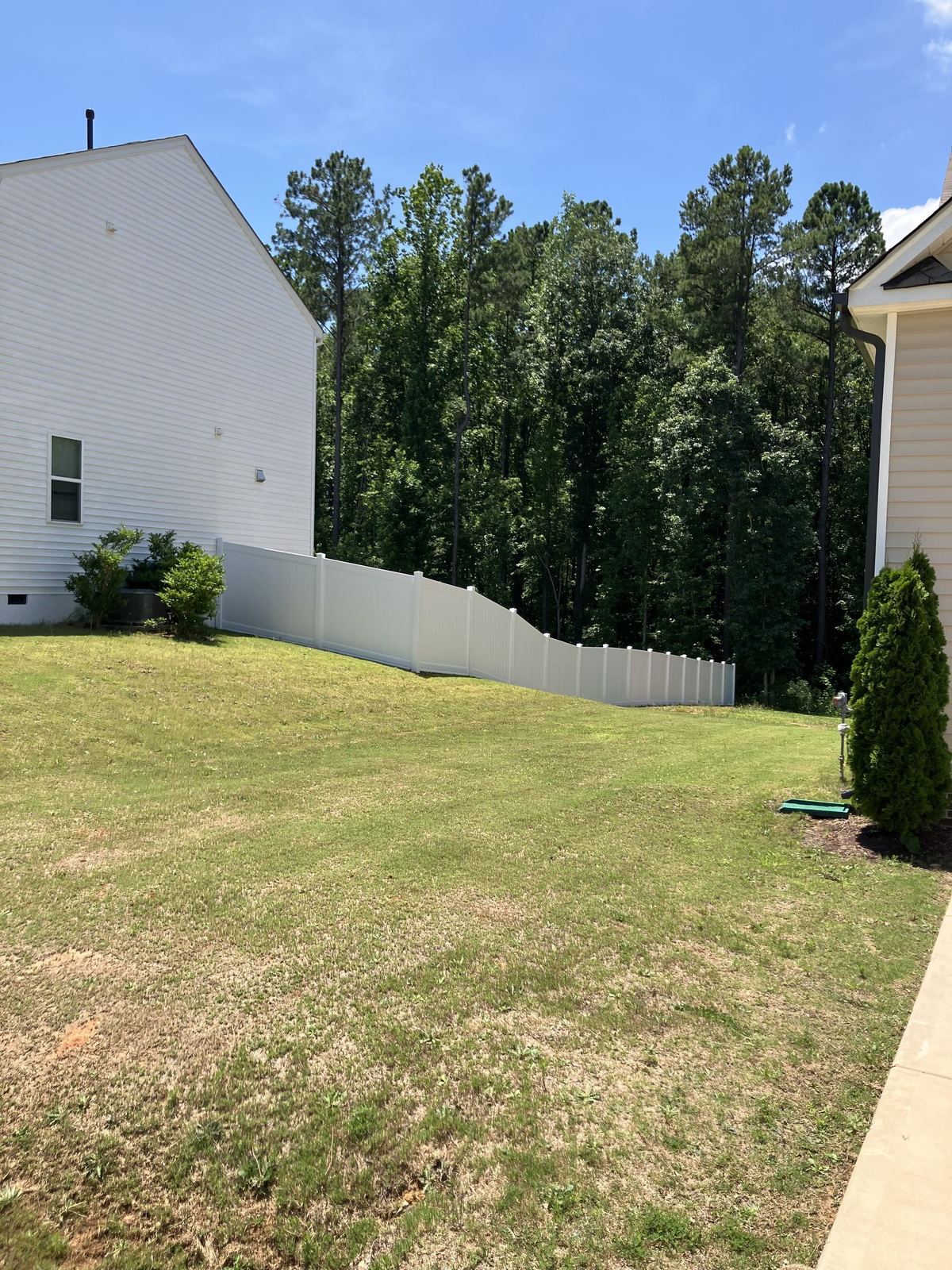 Wood privacy fence wrapping a backyard perimeter