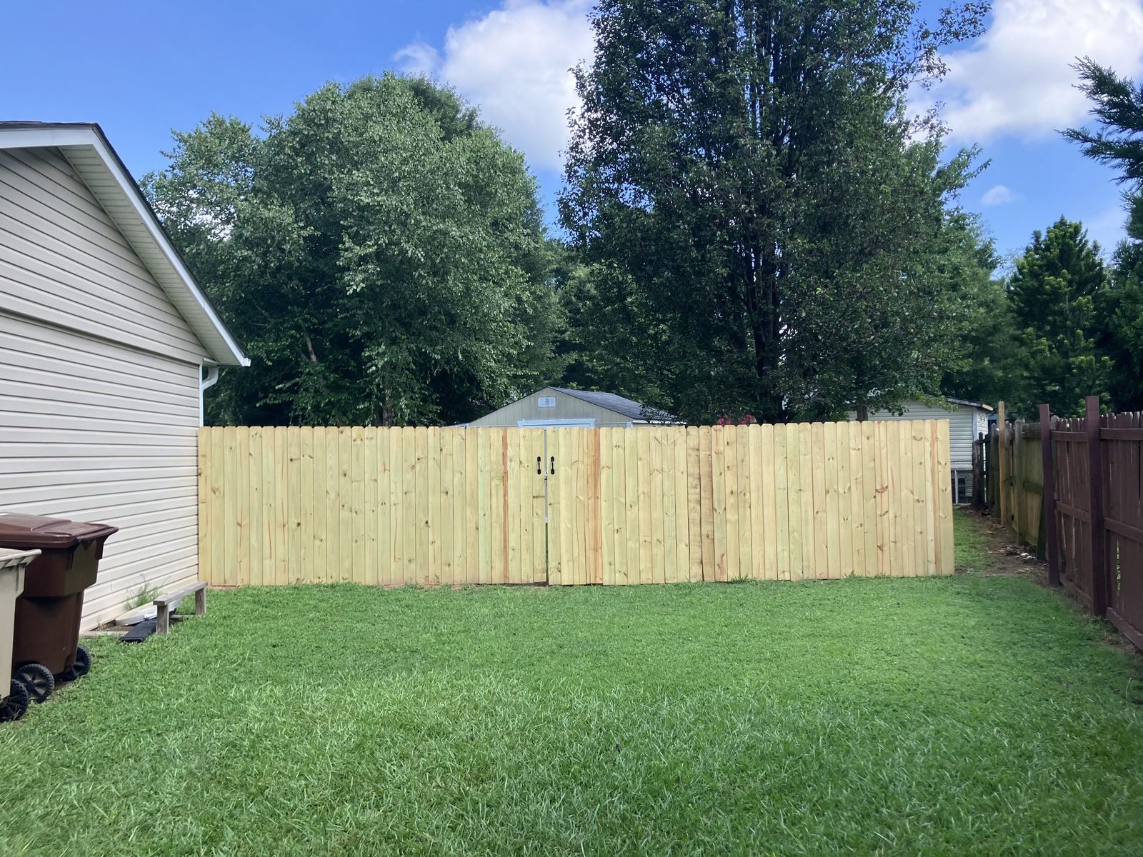 Finished wood privacy fence with center gate