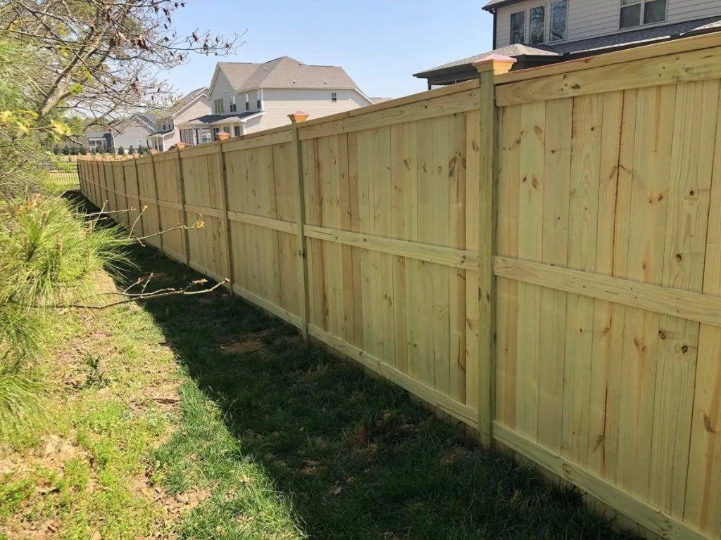 New wood privacy fence with capped posts