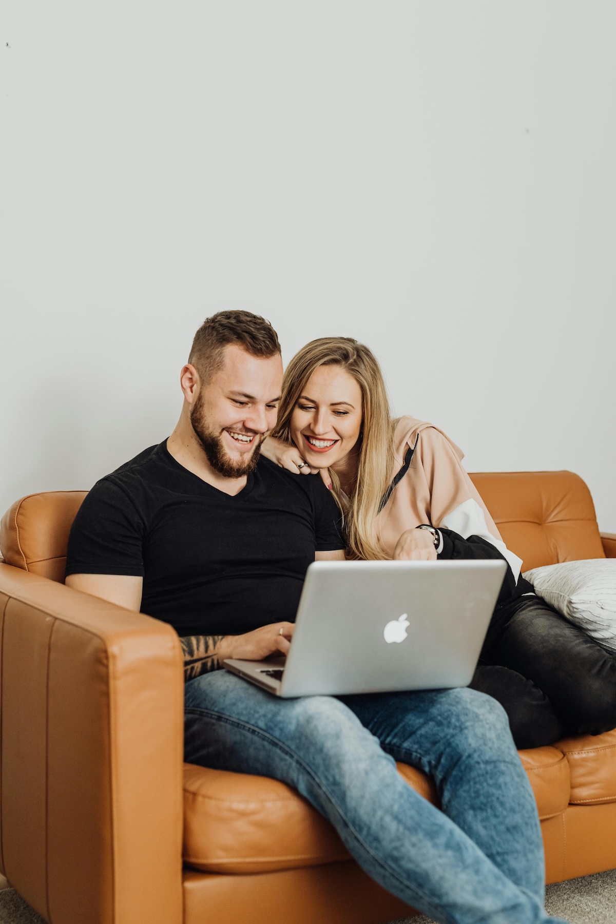A couple relaxing at home with a laptop