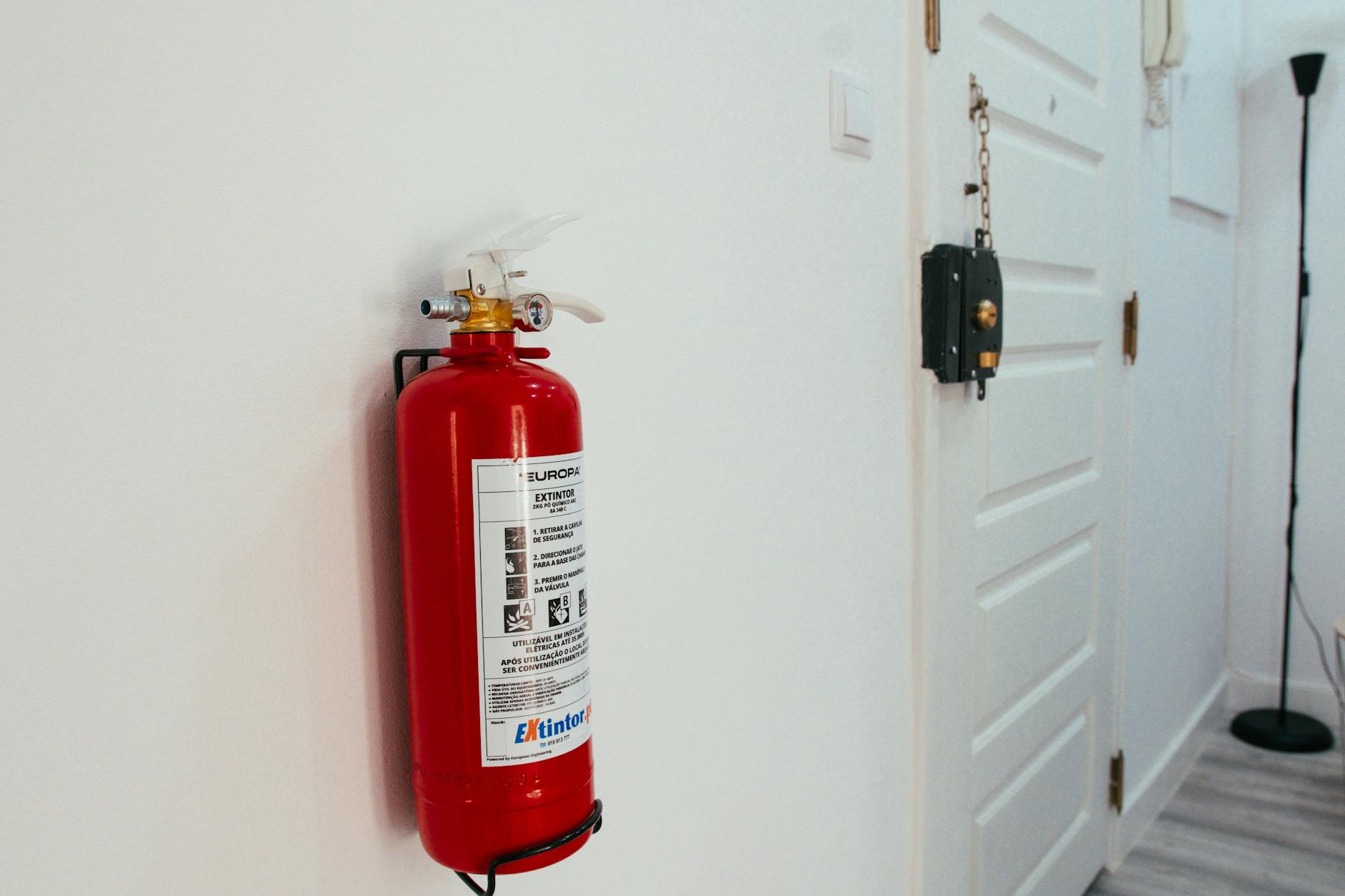 Fire extinguisher mounted on a wall inside a home