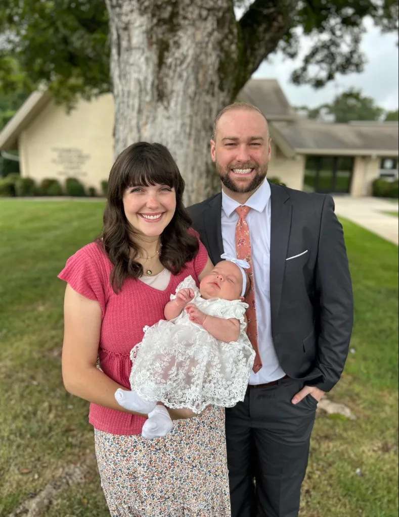 The Production Ready Engineering team outdoors, holding a newborn.